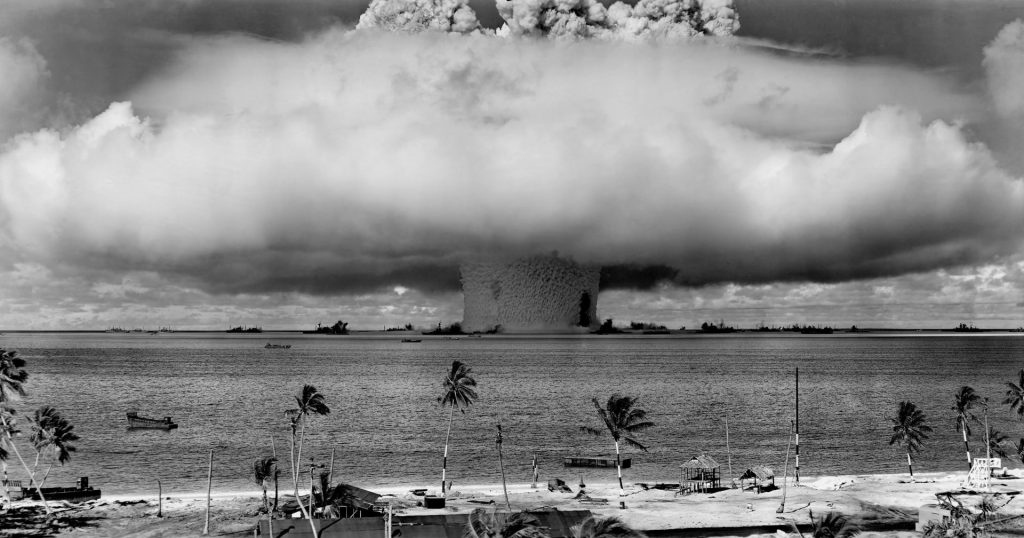 mushroom cloud grimly rises as atomic bomb explodes in ocean