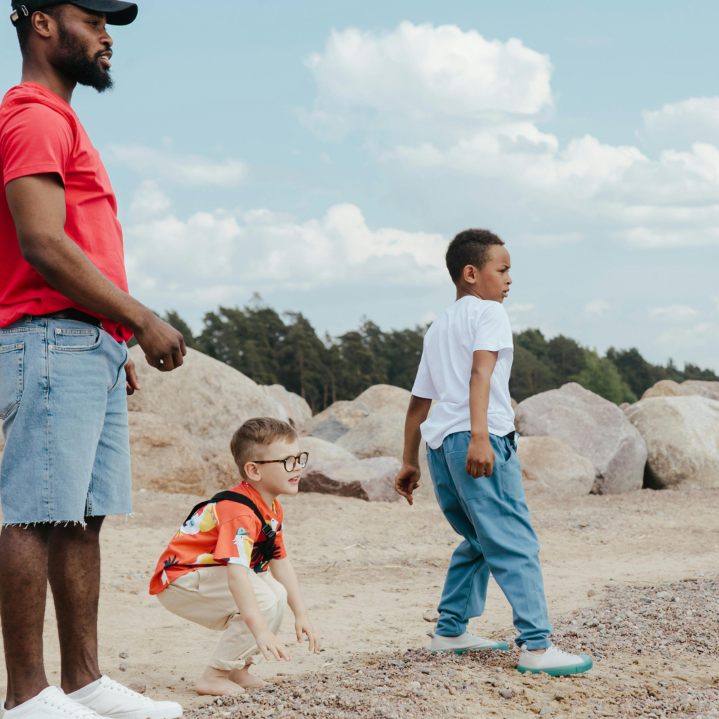 Dad and family skip rocks at beach